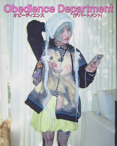 <img src=obedience_department.jpg alt=Individual with colorful outfit and phone in hand>