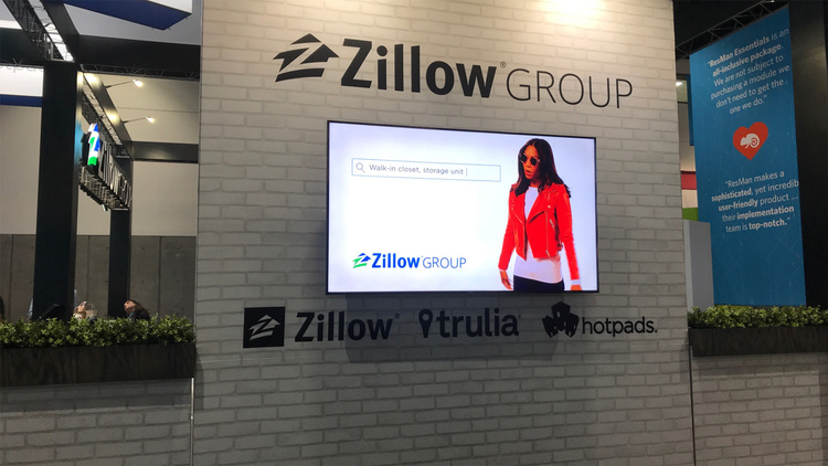 Zillow sign, woman on TV screen.